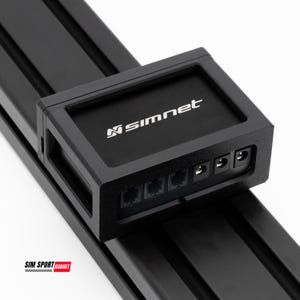 Könnte beinhalten: Ein schwarzes Simnet-Gerät mit dem Simnet-Logo in Weiß. Das Gerät verfügt über mehrere Anschlüsse und ist auf einer schwarzen Metallschiene montiert. Das Bild enthält auch den Text "SIM SPORT GADGET".
