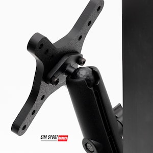 May include: Black metal bracket with multiple holes and a ball joint. The bracket is attached to a black cylindrical component. The text "SIM SPORT GADGET" is displayed in a red rectangle at the bottom.