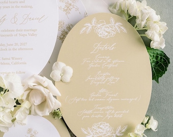 May include: Wedding invitation suite with floral accents. Includes invitation, RSVP card, details card, and place card with the name "James". The design features gold and white floral illustrations and real flowers.