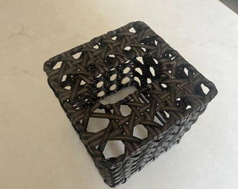 May include: A square-shaped woven tissue box holder made of dark brown wicker.