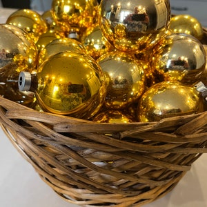 A Vintage Basket Filled with Vintage Gold Mercury Ornaments
