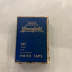 May include: A blue box with white text that reads "Greenfield" and "SET TAPER PLUG BOTTOMING HAND TAPS".