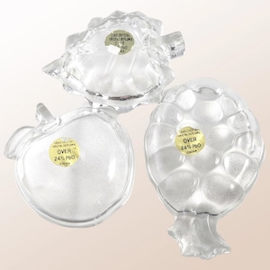 May include: Three clear glass fruit-shaped dishes with labels that read "Lead Crystal Cristal Deplomb Over 24% PbO China".