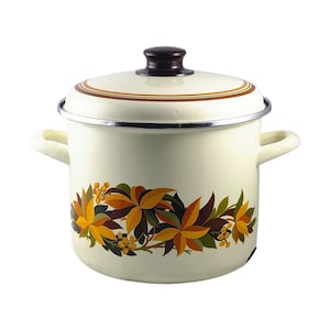 May include: White enamel pot with a brown lid and a floral design in shades of orange, yellow, and green.