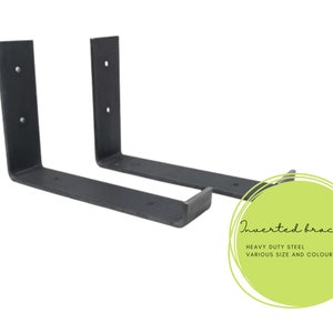 May include: Two black metal shelf brackets, also known as L brackets, are shown against a white background. The brackets are made of heavy duty steel and are available in various sizes and colours. The text "Inverted brackets" is written in a circle on the right side of the image.