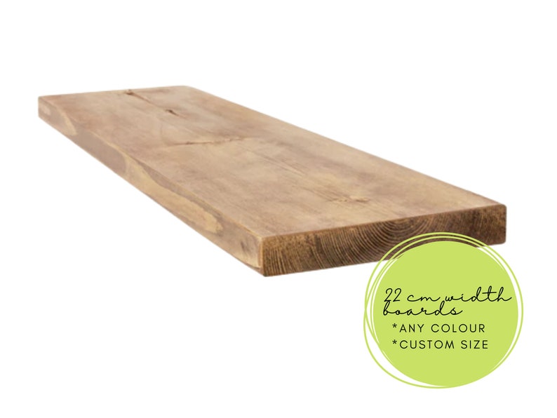 May include: A rectangular wooden board with a natural wood grain finish. The board is approximately 22 cm wide and appears to be a shelf or a similar home decor item. The image includes text that says "22 cm width boards *ANY COLOUR *CUSTOM SIZE".