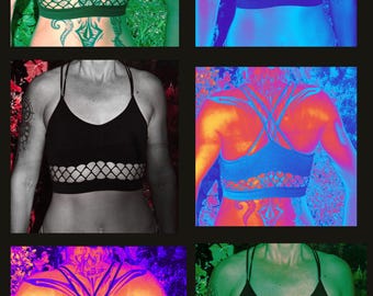 May include: A black sports bra with a mesh panel and criss-cross straps. The bra is shown in different color filters, including green, blue, red, and purple.