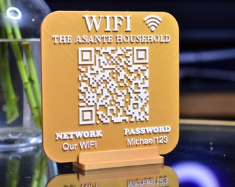 May include: A gold-colored sign with a QR code, the text "WIFI THE ASANTE HOUSEHOLD", and the words "NETWORK Our WiFi" and "PASSWORD Michael123".