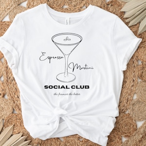 May include: White t-shirt with a black line drawing of an espresso martini glass. The text "Espresso Martini Social Club the foamier the better" is printed below the glass.