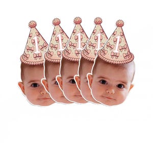 May include: Set of five pink and white party hats with a number one and bows. Each hat has a white background with pink polka dots and pink bows. The number one is white and the bows are pink. The hats are on a white background.