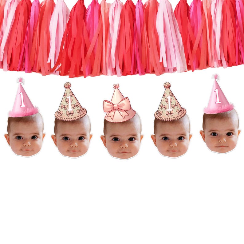 May include: A banner with pink and red tissue paper streamers and five pink and white party hats with the number "1" on them. Each hat is on a baby's face.