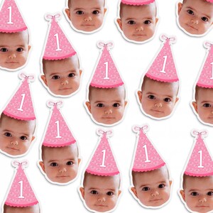 May include: A sheet of pink and white stickers featuring a baby wearing a pink party hat with the number "1" on it. The stickers are ideal for a first birthday party.