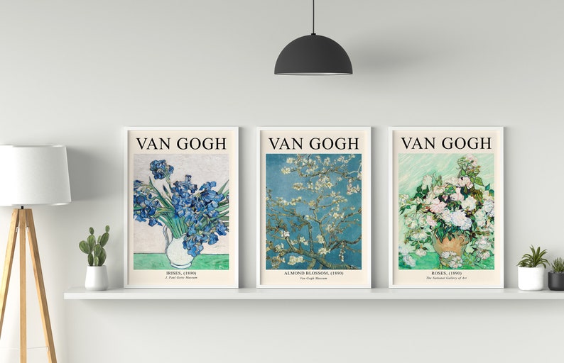 May include: Three framed prints of famous Van Gogh paintings. The first print features a bouquet of blue irises in a white vase. The second print shows a white almond blossom tree against a blue sky. The third print shows a bouquet of white roses in a brown vase.