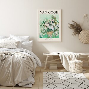 May include: A framed print of a painting by Vincent van Gogh titled "Roses, (1890)". The painting depicts a vase of white roses with a green background. The text "VAN GOGH" is at the top of the frame and the text "ROSES, (1890) The National Gallery of Art" is at the bottom of the frame.