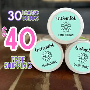 May include: Three 30 ml glass jars with white lids and turquoise labels. The labels have a black daisy design and the text "Enchanted Loaded Drinks". The text "30 Loaded Drinks $40 Free Shipping" is in pink and purple letters.