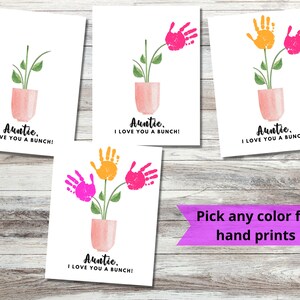 May include: Four printable cards with a handprint flower design. The cards say "Auntie, I love you a bunch!" and feature a pink pot with a green plant and handprints in pink, orange, and yellow. The text "Pick any color for hand prints" is written on a purple banner.