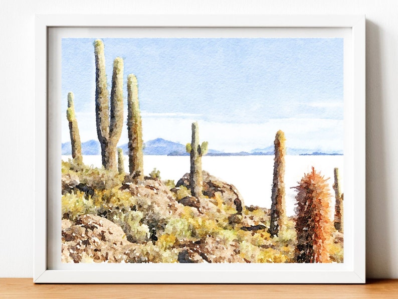 May include: A watercolor painting of a desert landscape with tall cacti and a distant view of a lake. The sky is a light blue and the water is a pale blue. The cacti are green and brown.