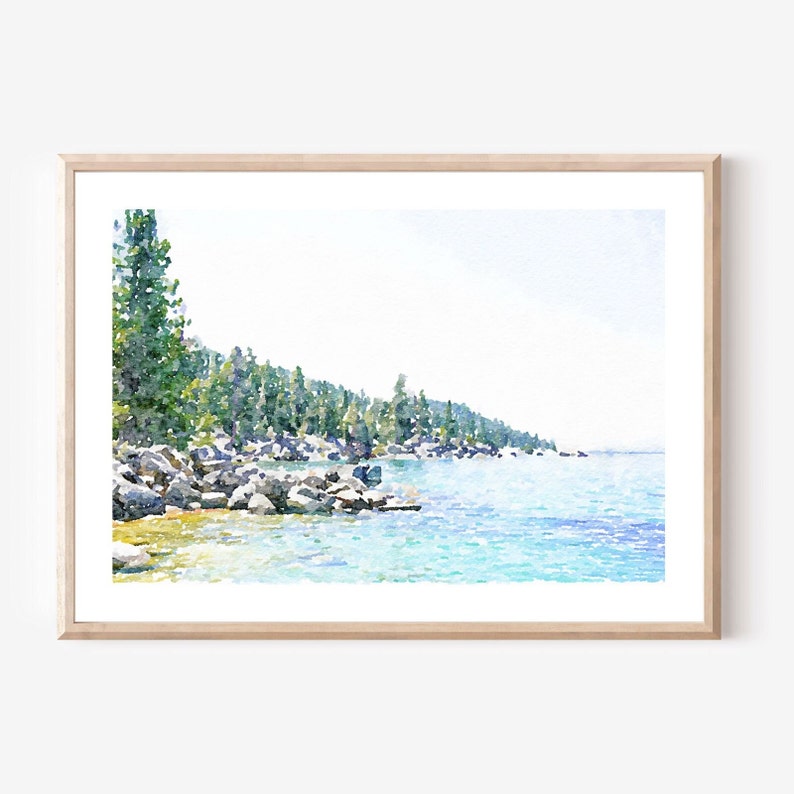 May include: A watercolor painting of a lake scene with a rocky shoreline and a line of trees in the background. The water is a light blue color and the sky is a light blue with white clouds.