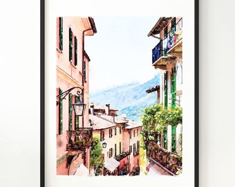 Peut inclure: Impression d'art aquarelle d'une scène de rue européenne. L'œuvre présente des bâtiments aux façades roses, des volets verts et des balcons. Une chaîne de montagnes est visible en arrière-plan, encadrée d'un cadre noir.