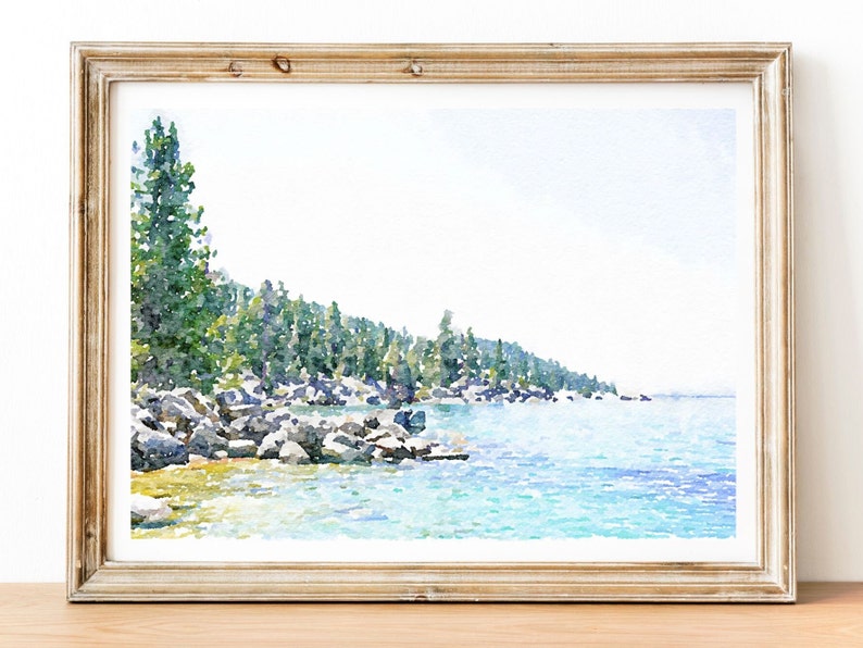 May include: Watercolor painting of a lake scene with a rocky shoreline and a line of trees in the background. The water is a light blue color and the sky is a light gray color.