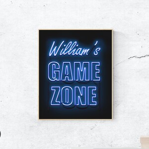 May include: A black and white digital print with blue neon text that reads "William's Game Zone".