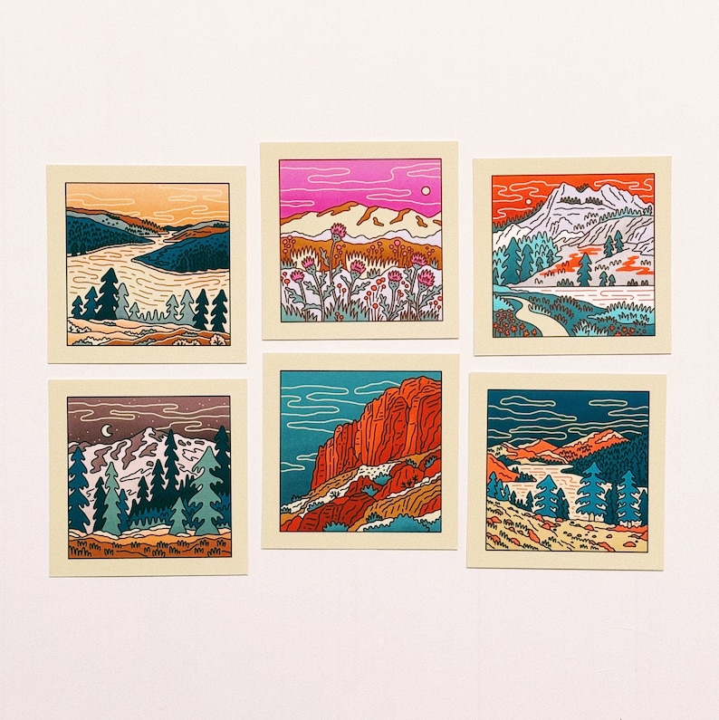 May include: Set of six illustrated cards featuring different landscape scenes. Each card has a colorful outline drawing of a mountain range, trees, and a body of water. The cards are printed on a cream-colored background.