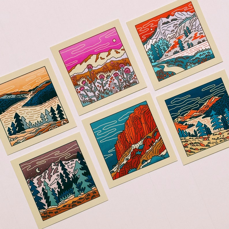 May include: Set of six illustrated cards featuring different landscapes. Each card has a unique color palette and features a mountain range, a forest, or a desert scene. The cards are printed on thick cardstock and have a matte finish.