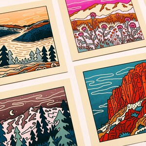 May include: Four illustrated cards featuring different landscapes. The first card shows a sunset over a river with trees in the foreground. The second card shows a pink sky with mountains and purple flowers. The third card shows a night sky with a crescent moon and a snowy mountain range. The fourth card shows a red rock canyon with a blue sky.