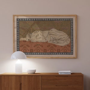May include: A framed print of a white tiger lying down on a patterned background. The tiger is depicted in a realistic style with detailed fur and markings. The background is a repeating pattern of flowers and leaves in shades of brown, green, and red.