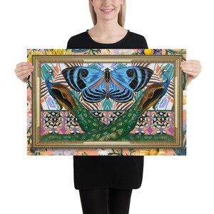 May include: A framed print featuring a blue butterfly with black and white markings, centered between two peacocks with green and blue plumage. The background is a colorful pattern of flowers, leaves, and geometric shapes.