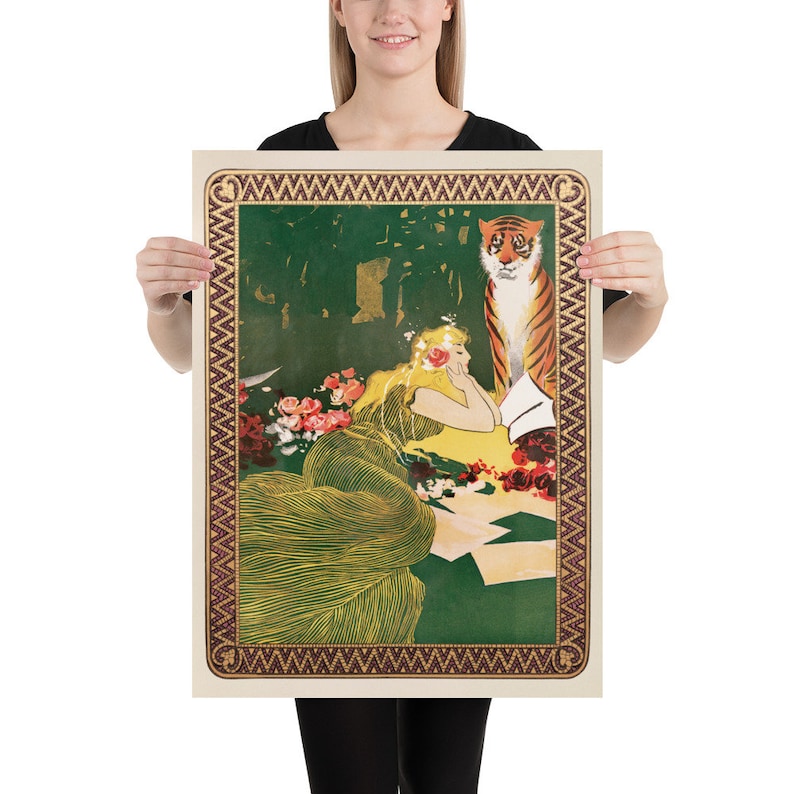 May include: A vintage poster featuring a woman in a green and yellow dress sitting in a garden with a tiger standing behind her. The poster has a decorative border with a repeating pattern.