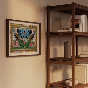 May include: A framed print of a colorful butterfly with peacock feathers on a patterned background. The frame is brown wood and the print is surrounded by a white mat.