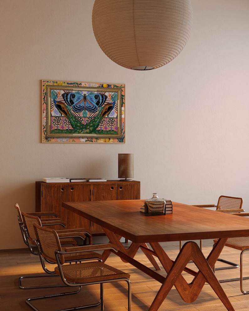May include: A wooden dining table with a unique A-frame base and four chairs. The table is set with a glass bottle and books. A framed artwork with a colorful butterfly design hangs on the wall behind the table.
