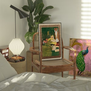 May include: A wooden chair with a woven cane seat and back, featuring a framed print of a woman and a tiger. The print has a gold border and a green background. A second framed print of a peacock with a pink background is on the wall behind the chair.