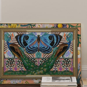 May include: A framed print with a colorful design featuring two peacocks with their tails spread out, a large blue butterfly, and a floral border.