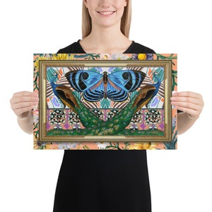 May include: A framed print featuring a blue butterfly with black markings, centered between two peacocks with green and blue plumage. The background is a peachy-orange with a floral pattern.