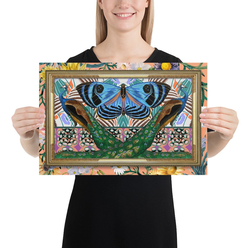 May include: A framed print featuring a blue butterfly with black markings, centered between two peacocks with green and blue plumage. The background is a peachy-orange with a floral pattern.
