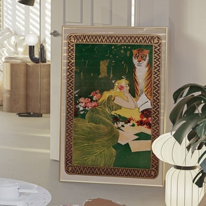 May include: A framed vintage illustration of a woman in a green dress with a tiger behind her. The woman is lying down and looking at the tiger. The illustration is set against a green background with flowers.