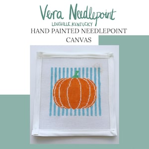 May include: Hand-painted needlepoint canvas featuring an orange pumpkin with a green stem, set against a backdrop of blue vertical stripes. The canvas is framed with white fabric and includes the text "Vera Needlepoint, Louisville, Kentucky".