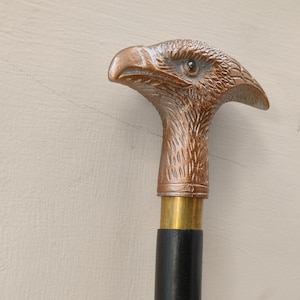Walking stick, wooden cane,eagle handle,spiral design,three fold,black color