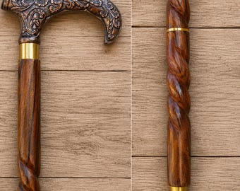 May include: A wooden walking stick with a dark brown, twisted shaft and a decorative handle. The handle is bronze-coloured with an ornate floral design. The stick has gold-coloured metal accents at the top and bottom of the shaft.