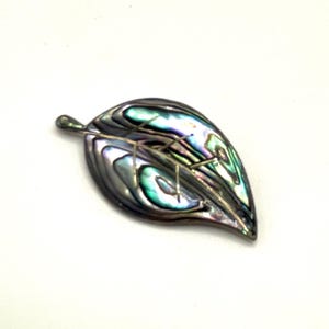 May include: A leaf-shaped brooch with iridescent abalone shell inlay. The brooch features a silver-tone metal outline and veining, with shades of green, blue, and purple. The leaf is approximately 2 inches long.