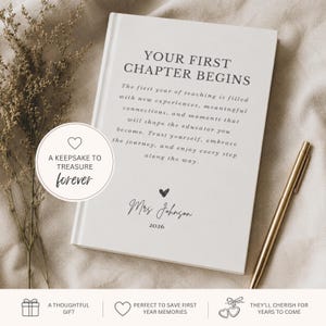 May include: A white hardcover journal featuring the text YOUR FIRST CHAPTER BEGINS, followed by a paragraph about the first year of teaching, and the name Mrs. Johnson with the year 2026. A circular badge reads A KEEPSAKE TO TREASURE FOREVER.