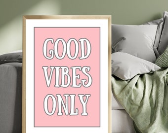 May include: A framed print with a pink background and the text "GOOD VIBES ONLY" in white letters.