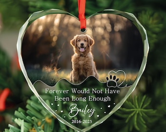 May include: Heart-shaped clear glass ornament with a photo of a golden retriever dog. The ornament has a red ribbon for hanging and includes the text "Forever Would Not Have Been Long Enough" and the name "Bailey" with dates.