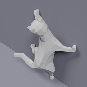 May include: A white origami cat sculpture in a playful pose, with its front paws raised and its back legs extended. The sculpture is made of folded paper and has a geometric design.