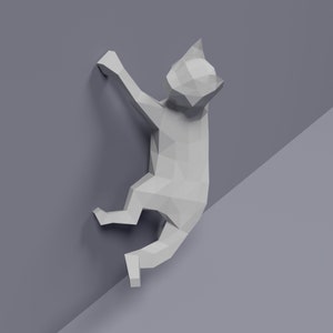 May include: A white origami cat sculpture climbing a wall. The cat is made of paper and has a geometric design.
