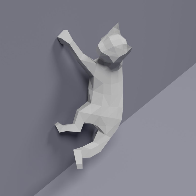 May include: A white origami cat sculpture climbing a wall. The cat is made of paper and has a geometric design.