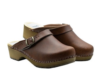 Closed handmade wooden clogs with a decorative buckle made from real leather and alder wood for women and men by BrescoClogs in brown colour