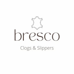 May include: The logo for "bresco" features the brand name in a dark brown serif font, with the words "Clogs & Slippers" below. Above the name is a stitched leather icon, all set against a white background.